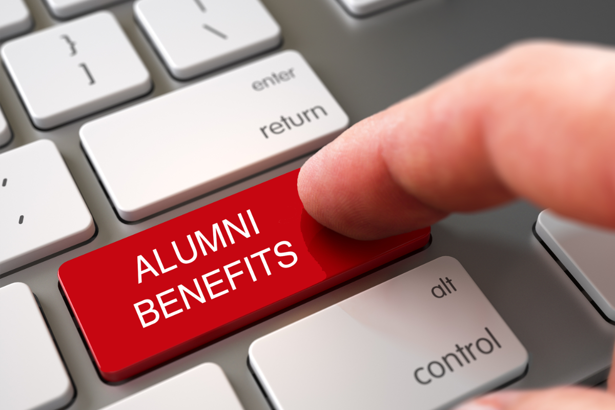 Keyboard with person hitting Alumni Benefits button