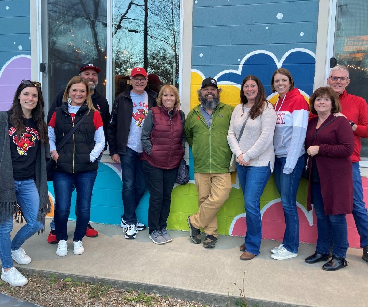 Asheville Club group photo with colorful background