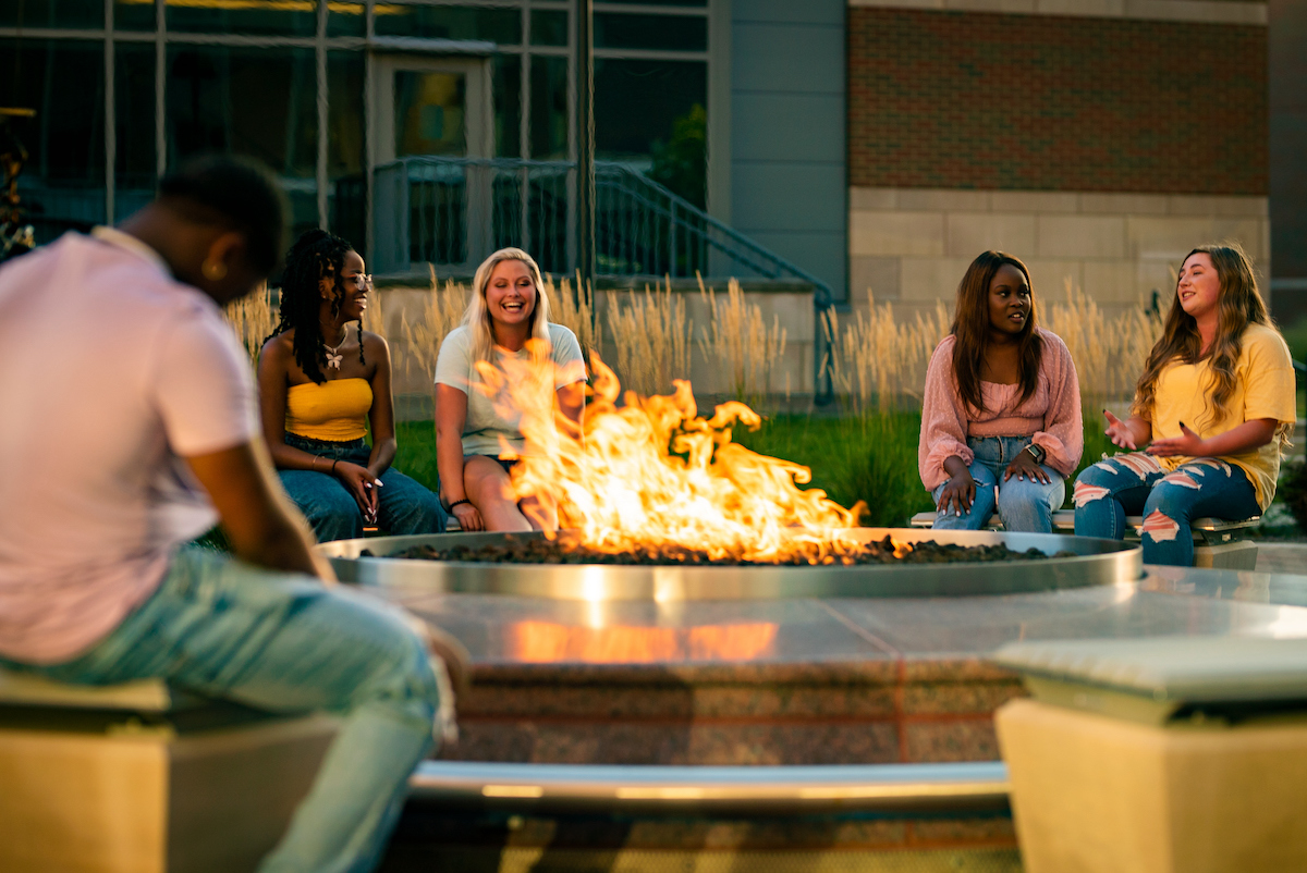 People talking around fire pit