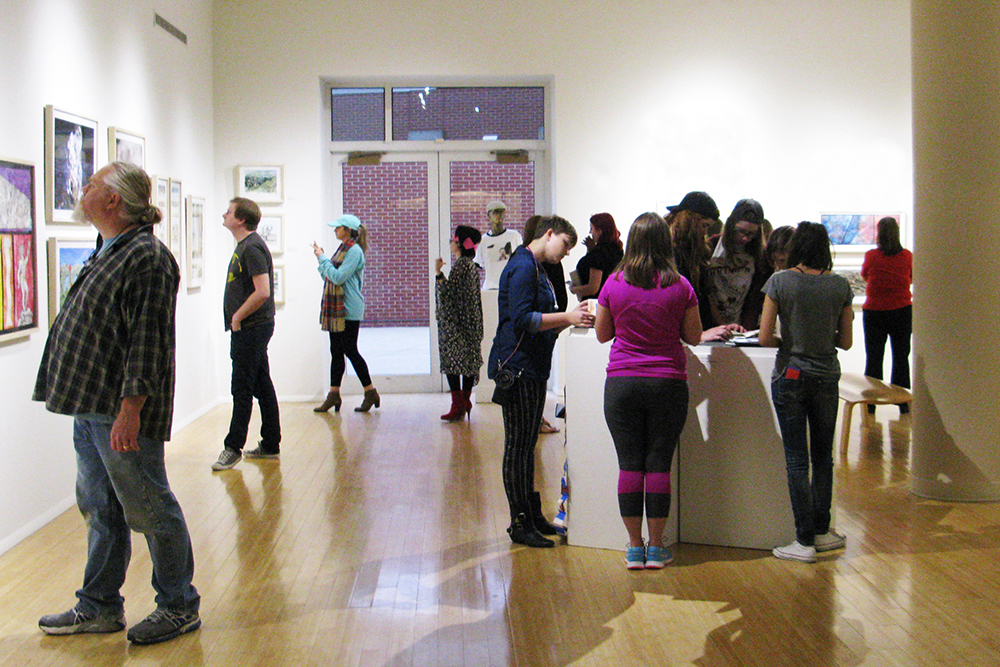 Atrium gallery with students browsing the exhibits