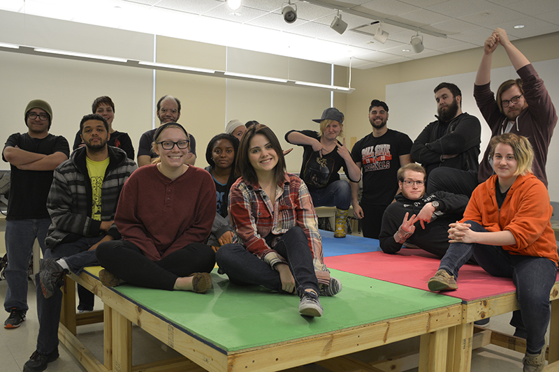 a group of art students setting on a table