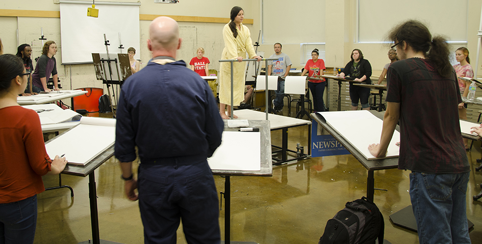 students in a drawing lab working with a model