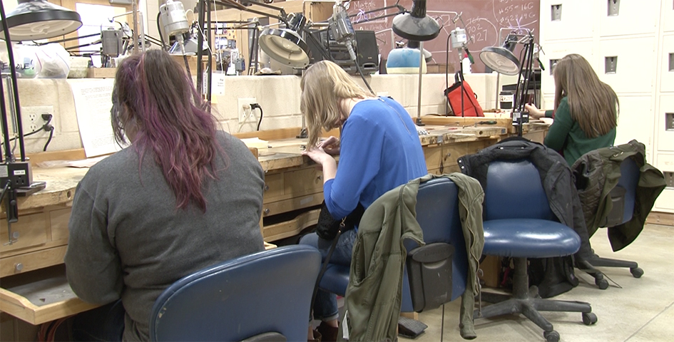 students metal working in a lab