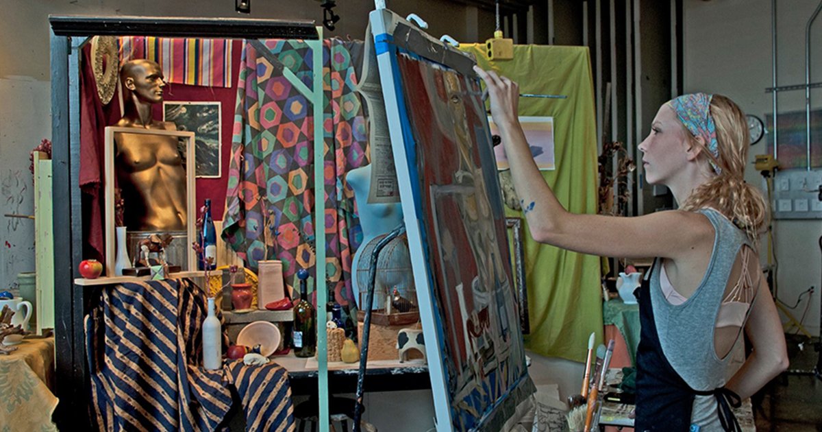 student painting on large canvas