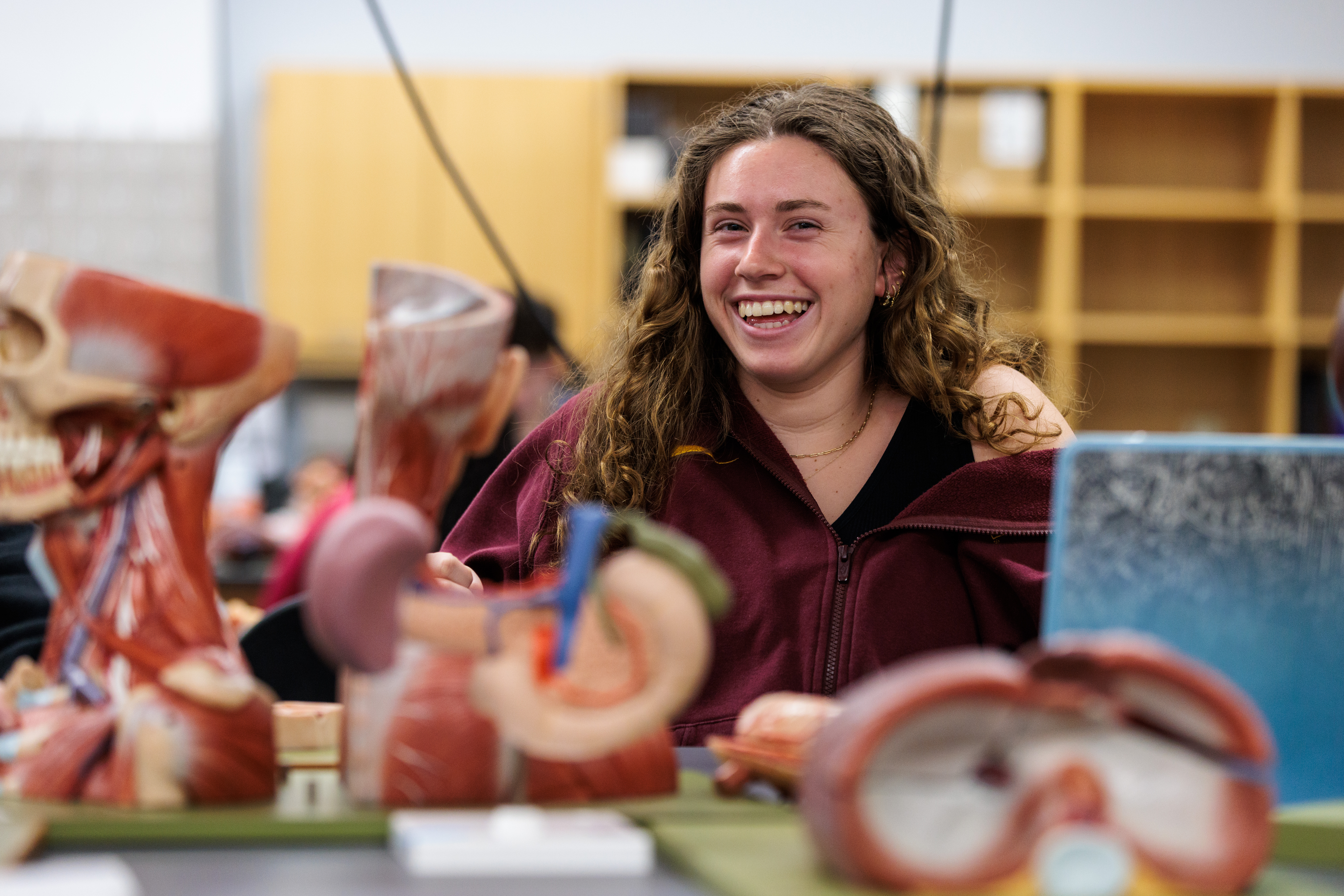 Student surrounded by anatomy models