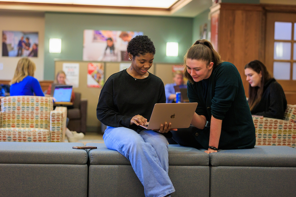 Students looking at laptop