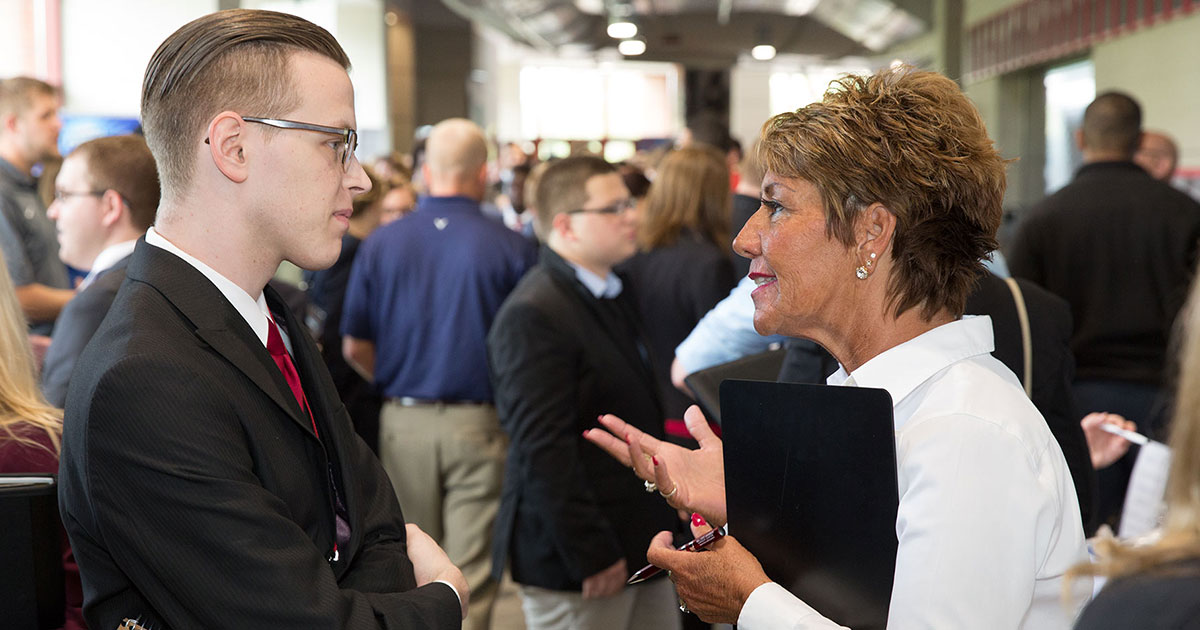Student talks with employer