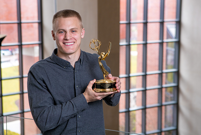 TCOM Student with Emmy Award