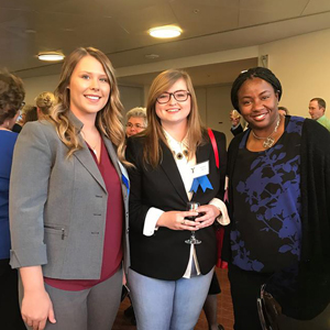 three students smiling
