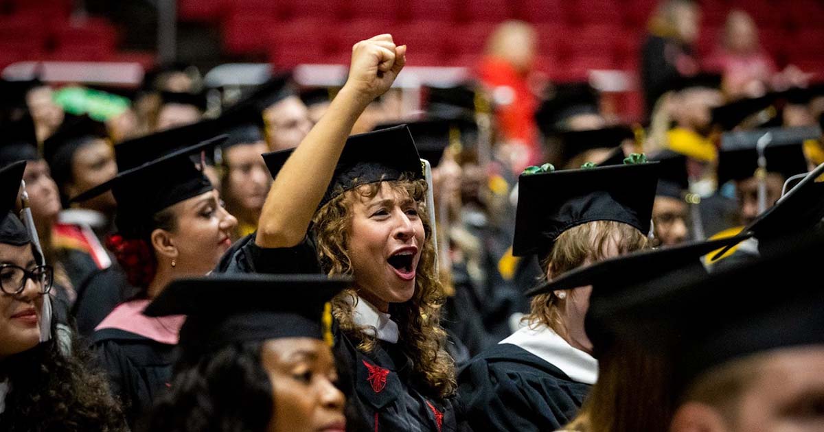 Graduate celebrating in crowd