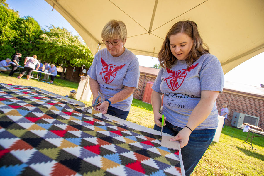 two women cutting fabric