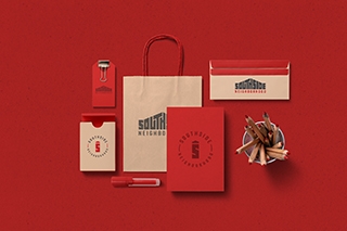 Various red and cream colored marketing materials arranged on a red background