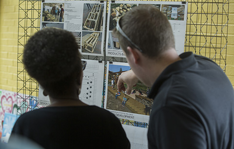 Two people looking at a rendering