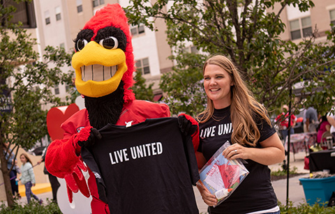 Charlie Cardinal and a girl with Live United t-shirts