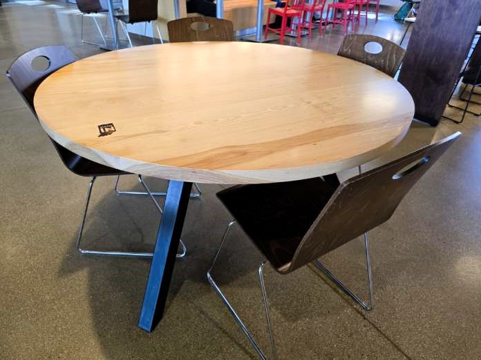 Table made with local Indiana wood with four chairs placed around it.