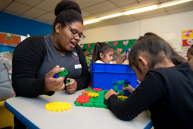A Ball State student works with a child.