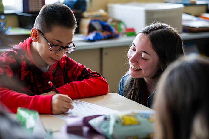 Ball State Education student helping a younger student with their homework