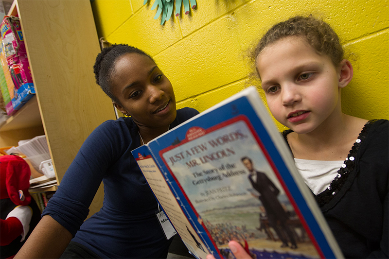 Ball State student reads with girl