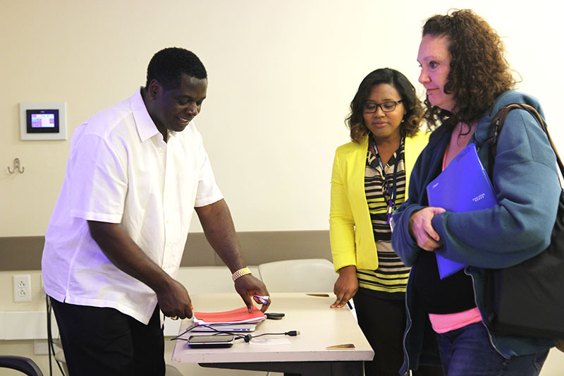 A group of students working with a teacher.
