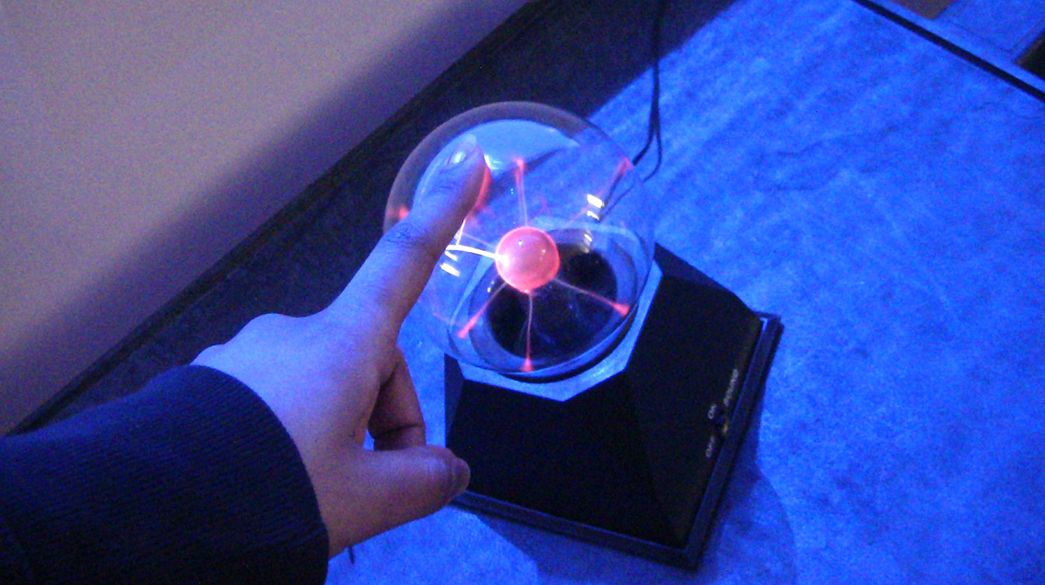 A student touching lighting equipment.