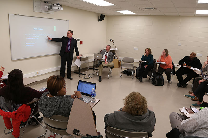 A teacher giving a presentation in the classroom.