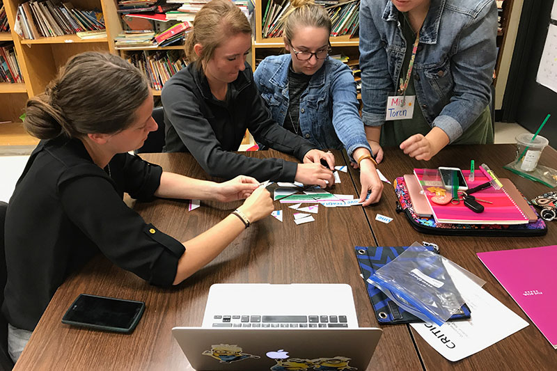 A group of students working with technology.