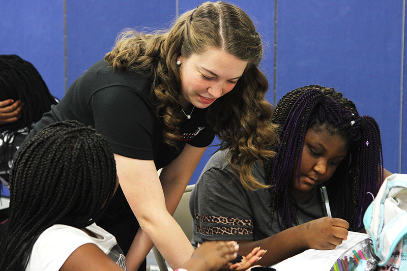 A teacher working with a group of students.