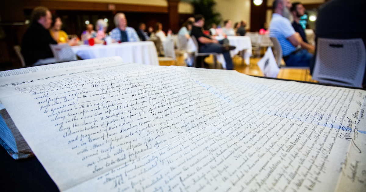 View of professional development event attendees listening attentively to a panel discussion about American democracy 