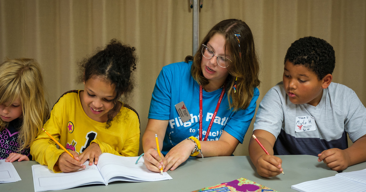 Ball State Teacher trainee engaging elementary school kids in learning activity about civic responsibility