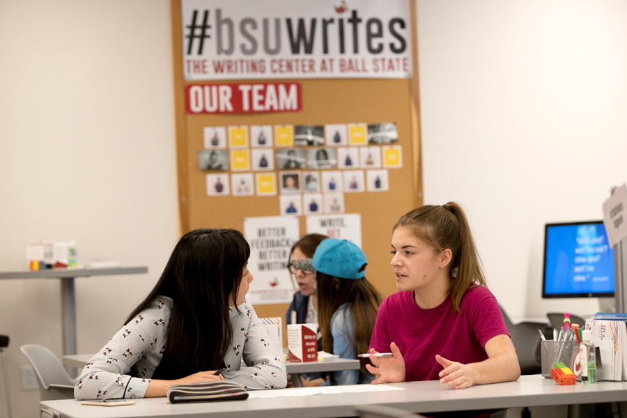 two female students talking in the Writing Center