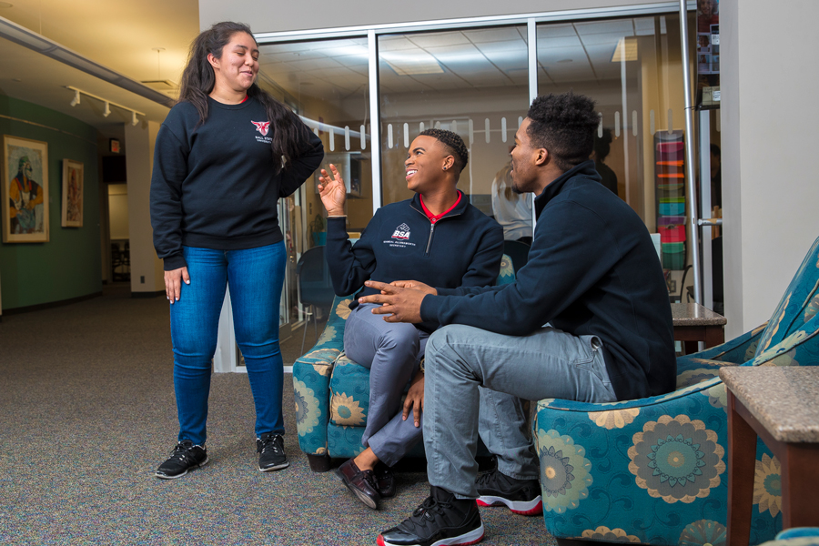 three students talking