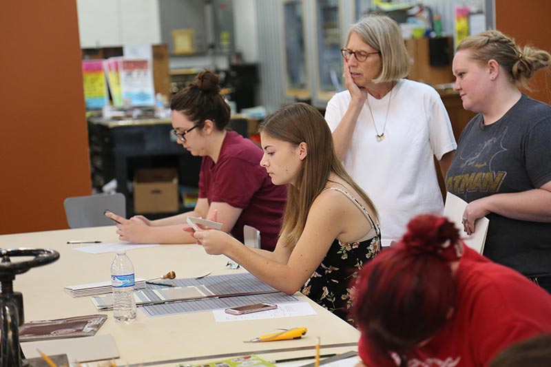 A professor working with a group of students.