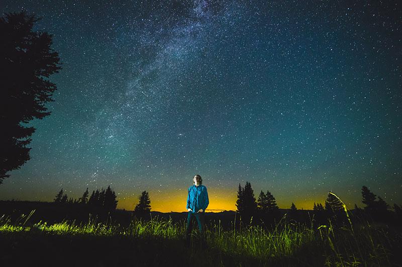 A person staring up at the night sky.