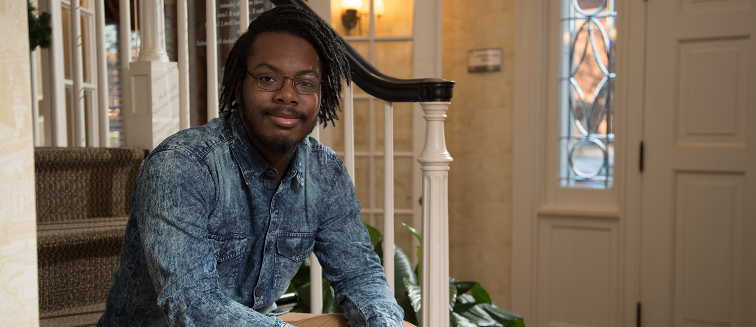 Lavonte Pugh, honors student inside the front door to the Honors House