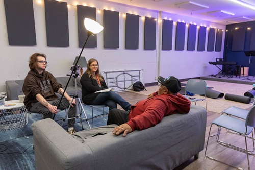 A student and professor conduct an interview at Recovery Cafe