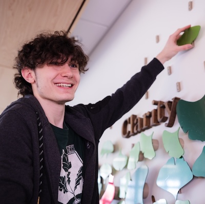 Digital Corps student help hang a Fabrication Lab project