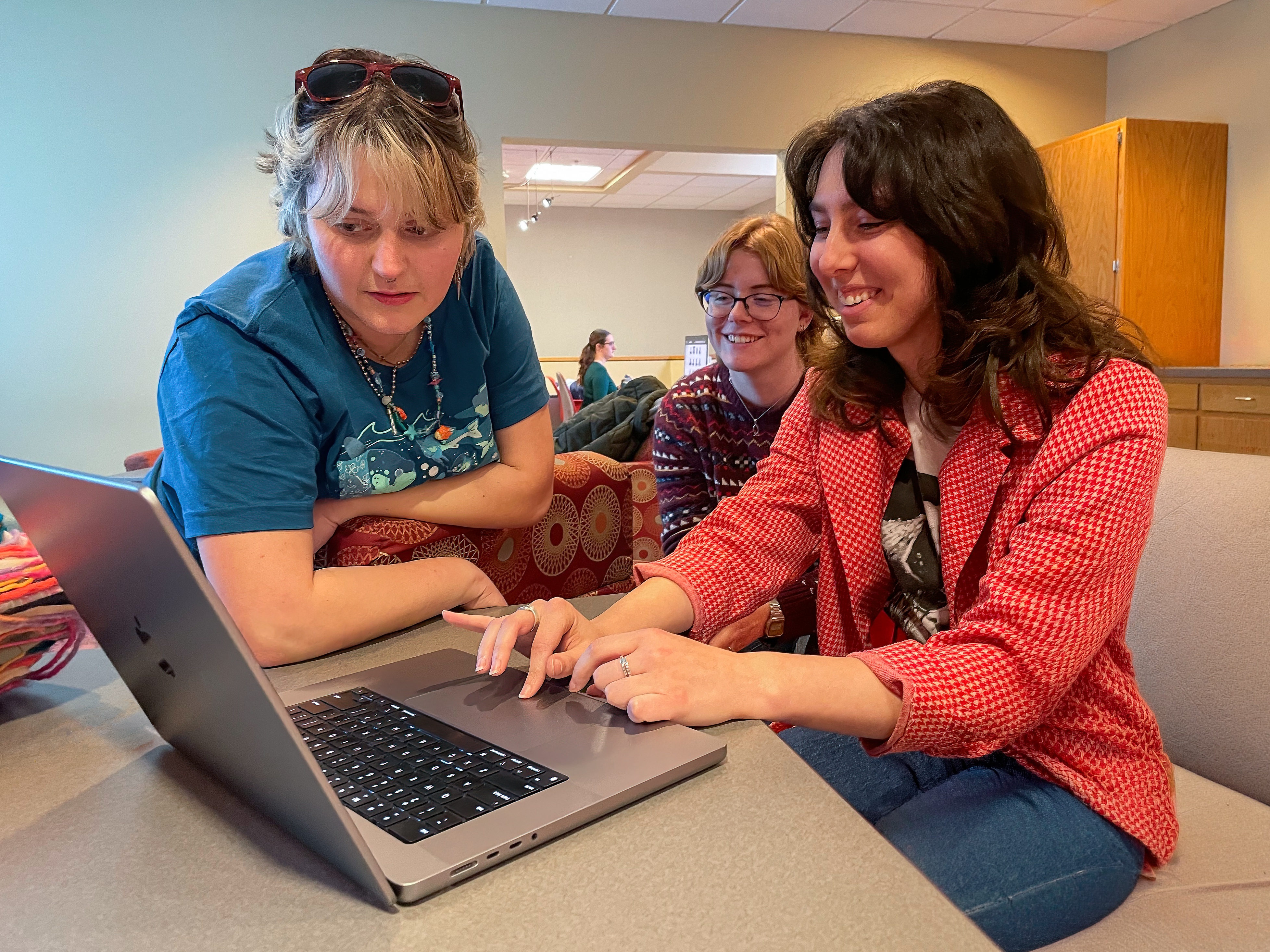 Digital Corps students collaborating together with a computer