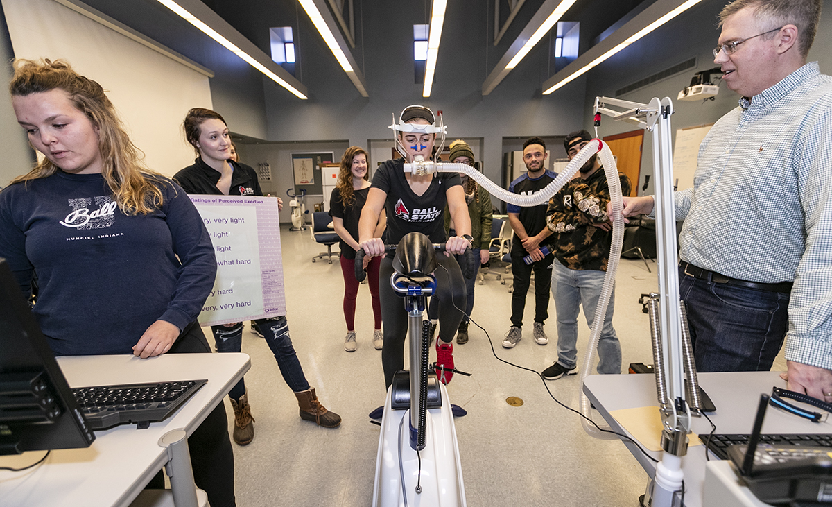 Students attending a laboratory session with a professor