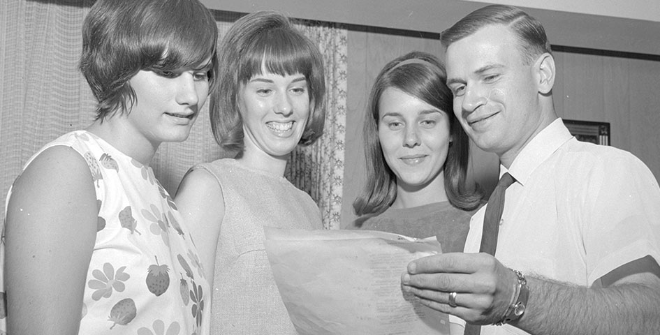 Professor reviews paper with students