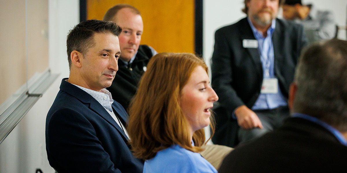 Professionals Discussing Business Topics with Students