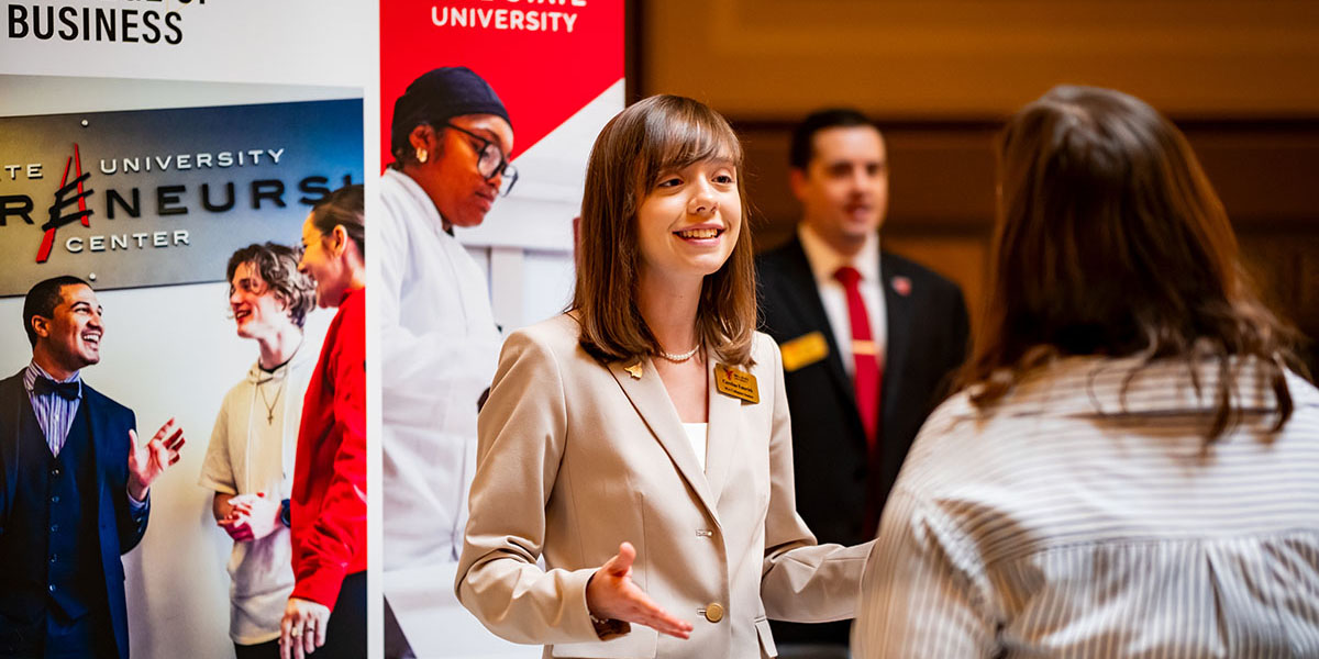 Miller College Undergraduate Fellow speaking with a prospective student