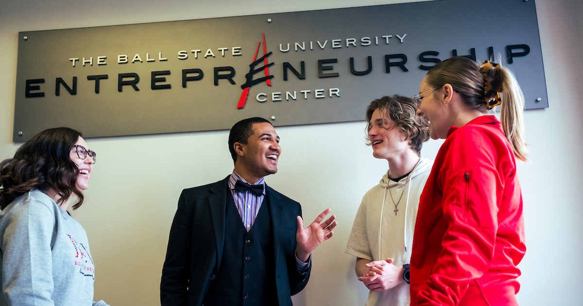 Miller College of Business students standing underneath the Entrepreneurship Center sign