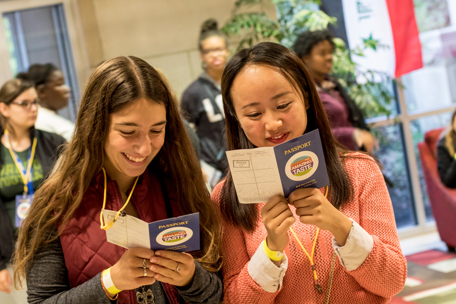 students smiling, reading a brochure