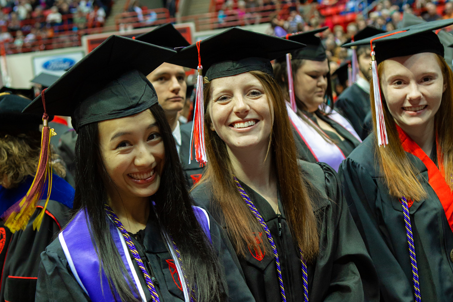 students wearing caps and gowns at commencement