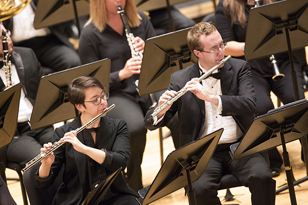 students playing flutes on stage