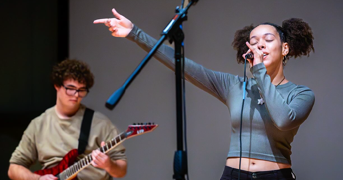 Singer performs on stage.