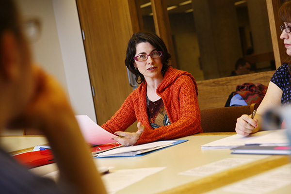 Julie Lyn Barber working with colleagues around a table