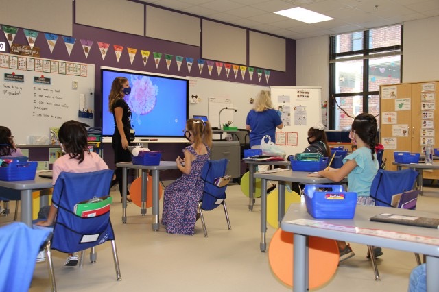 Maria Schultz teaches in a classroom with young students