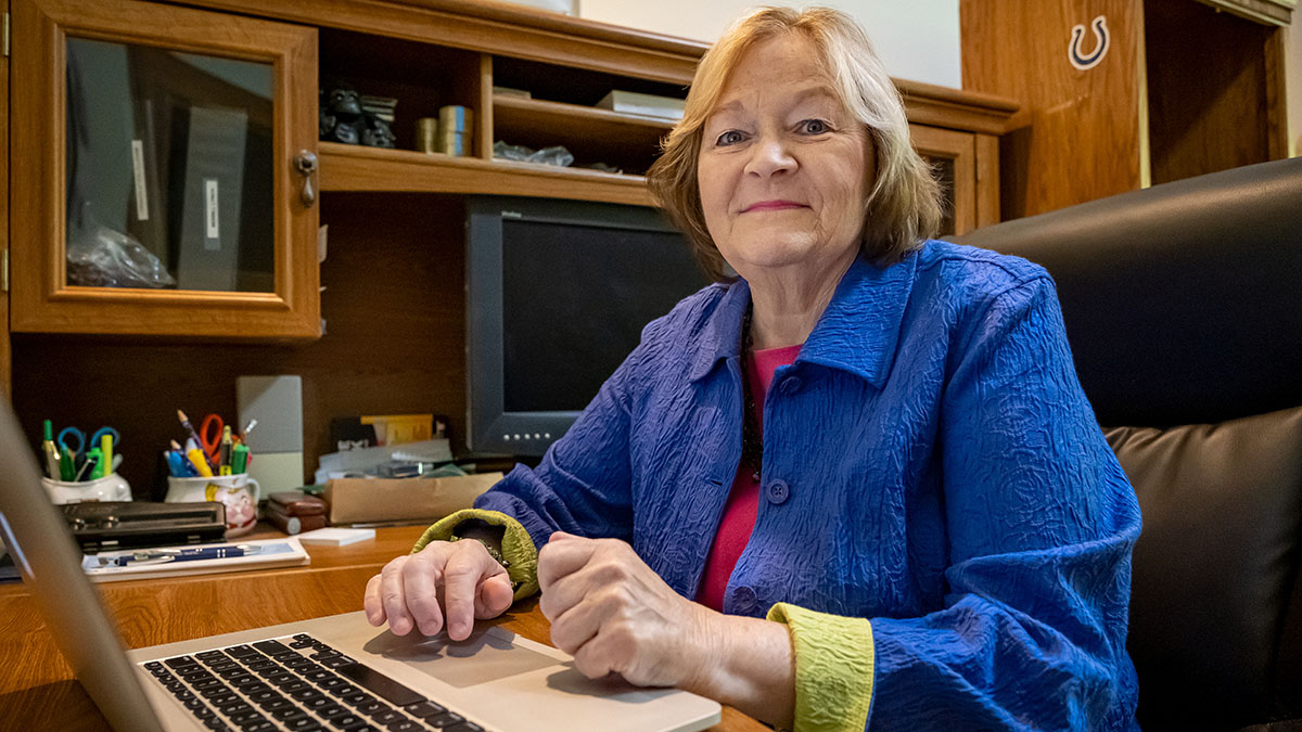 Woman seated at a desk with laptop