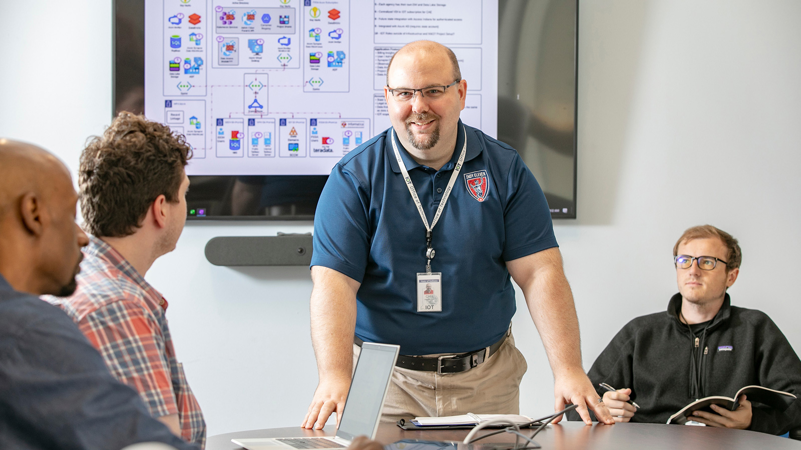 Chris Henderson smiling in a conference room